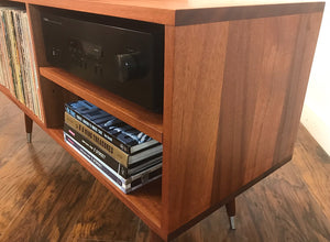 Solid mahogany turntable and stereo console with album storage.