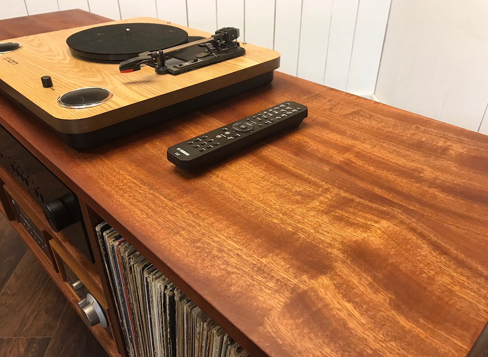 Solid mahogany turntable and stereo console with album storage.