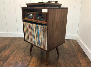 Solid walnut stereo console with album storage.