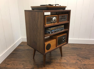 Solid walnut stereo console with album storage.