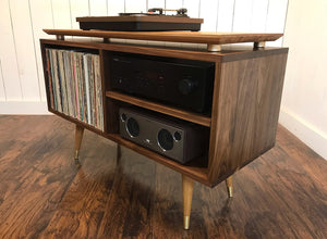 Solid walnut and white oak turntable/stereo console with isolation platform and album storage.